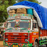 Decorated truck with cargo on a road in a rural setting